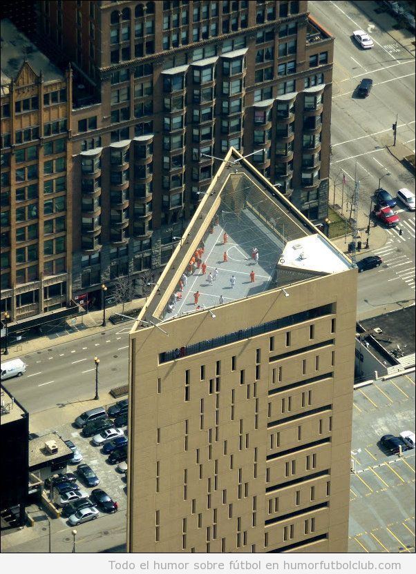 Foto curiosa de edificio triangular con pista de fútbol y basket en la azotea