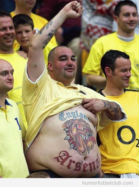 Hincha con pinta de hooligan con un tatuaje del Arsenal en la barriga