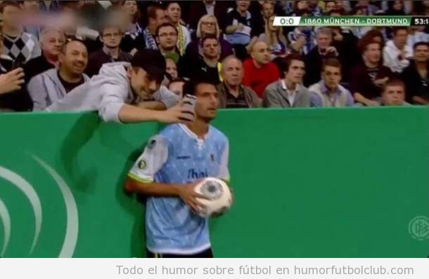 Foto graciosa de un aficionado sacando una autofoto con un jugador del Bayer de Munich en un saque de banda